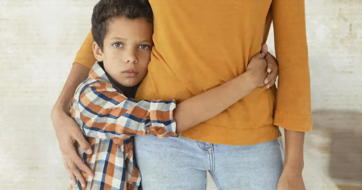 Child hugging his mother/guardian